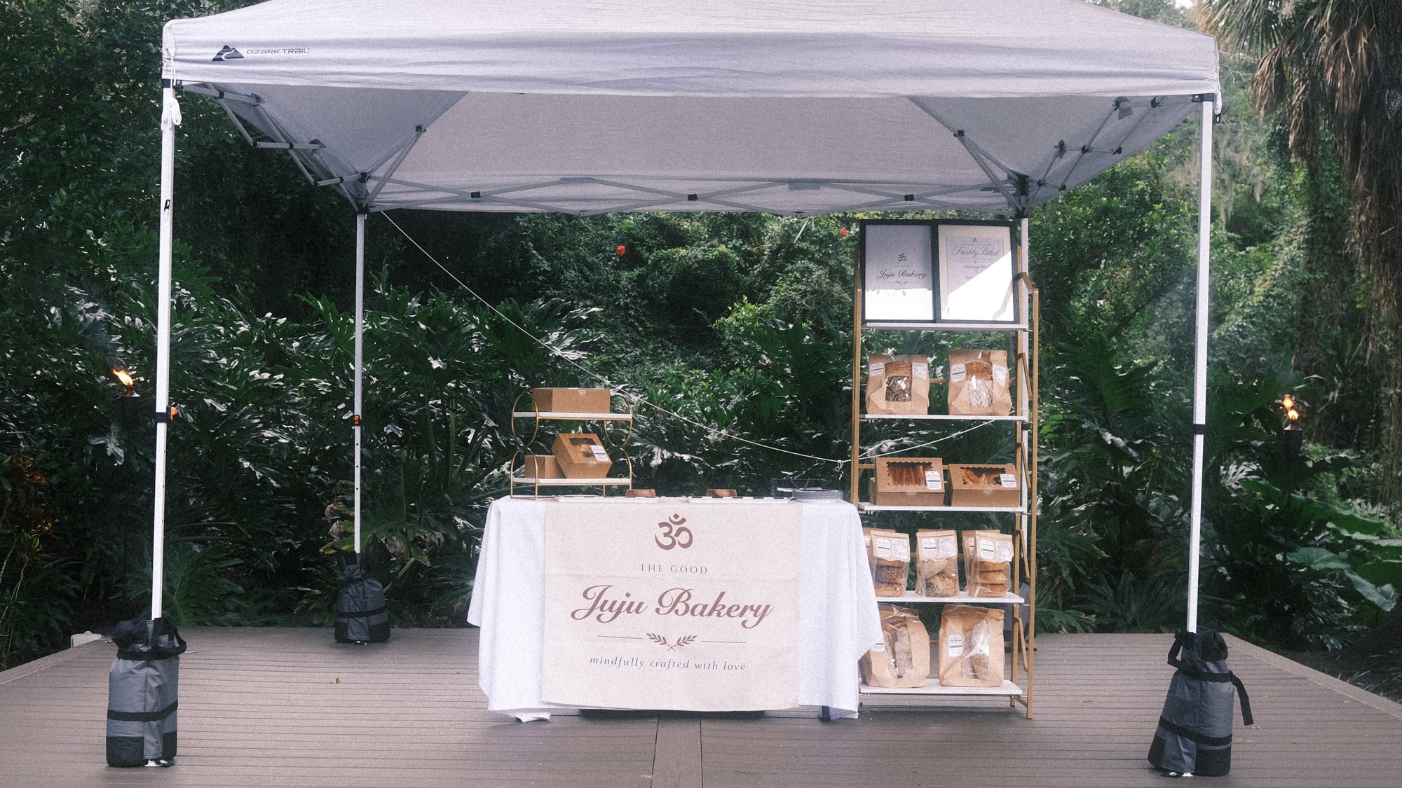 The Good Juju Bakery market table set up under a tent, ready for The Heights Night Time Market